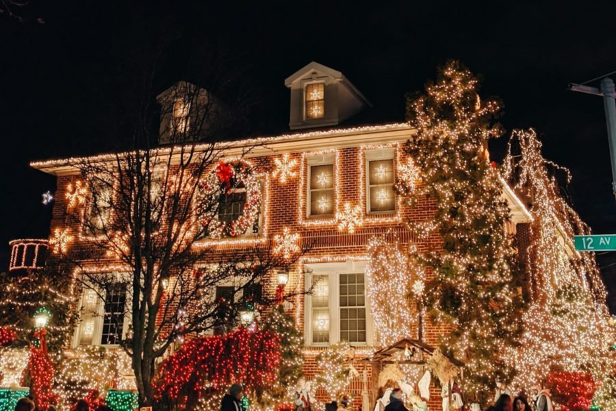 A home professionally lit with warm white Christmas lights at dusk